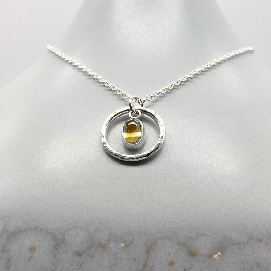 Oval cabochon citrine pendant necklace in silver hammered ring