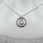 Round cabochon moonstone pendant necklace in silver hammered ring