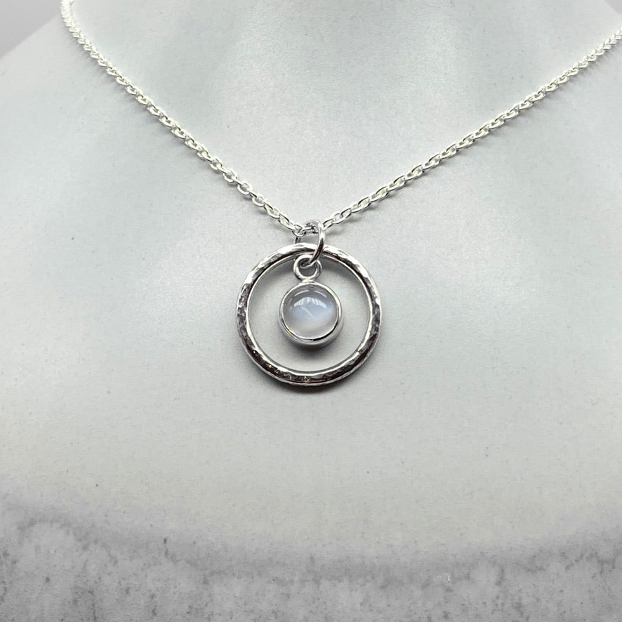 Round cabochon moonstone pendant necklace in silver hammered ring